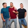 Thee Gebogen Models standing together laughing,